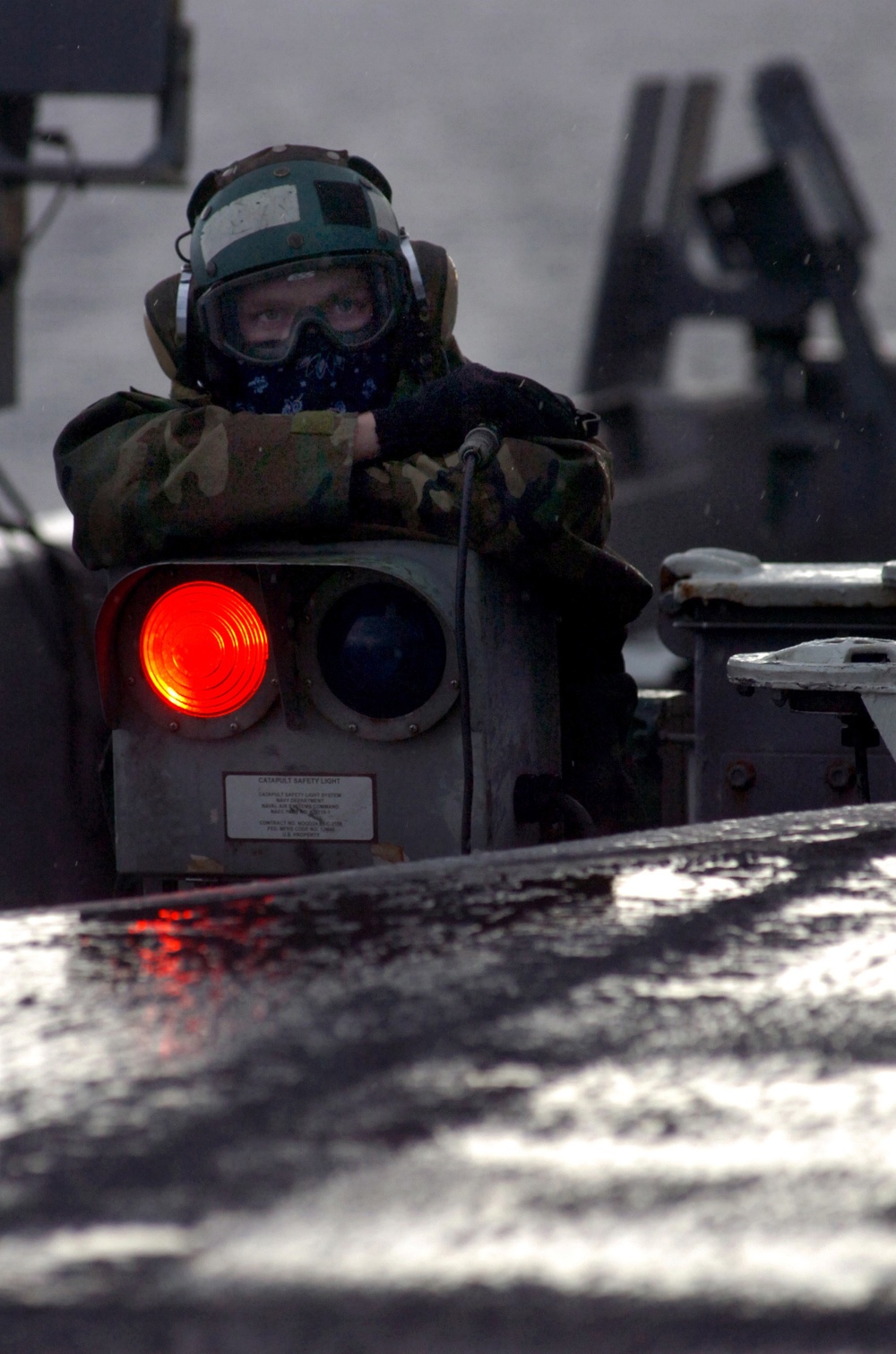 A U.S. Navy Airman keeps watch on activities on the flight deck.