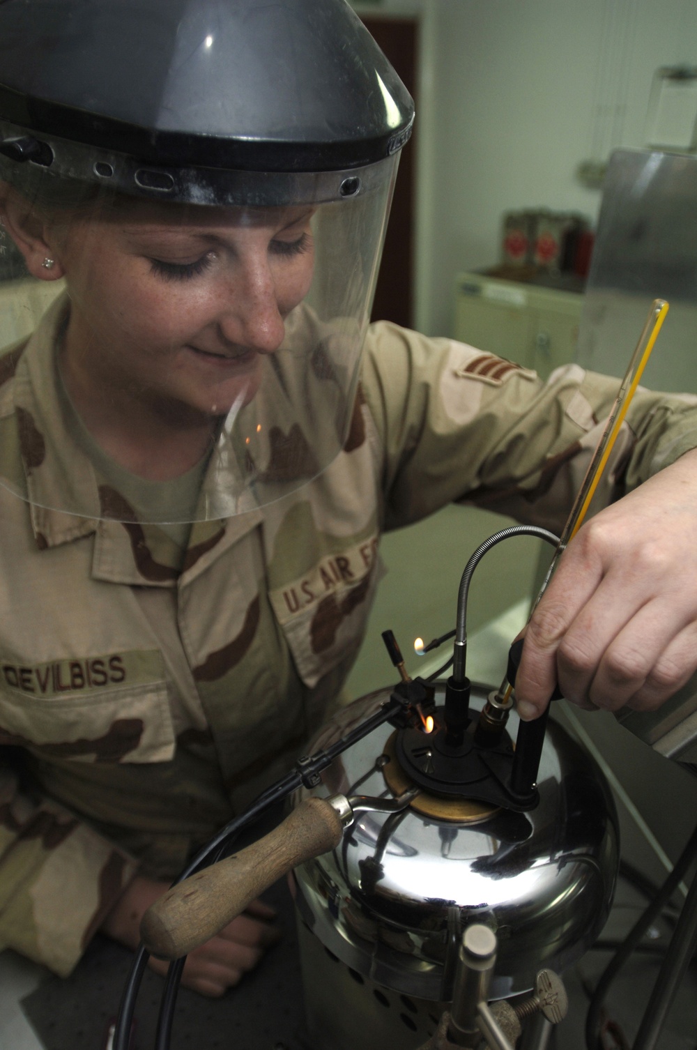 Senior Airman Alicia Devilbiss tests the flash point of JP8 aircraft fuel.