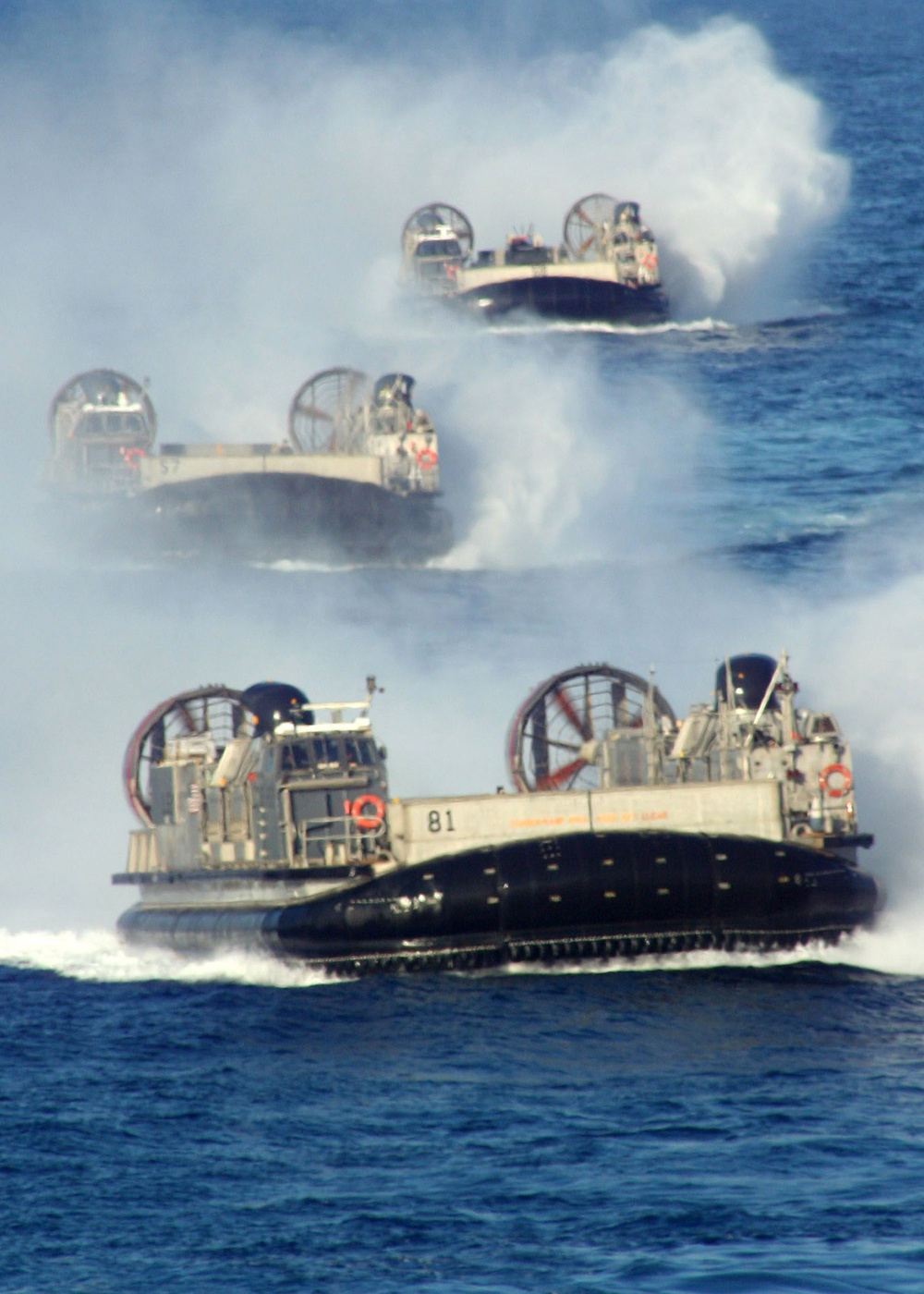 Three U.S. Navy Landing Craft Air Cushion prepare to enter the well deck of USS Tortuga.