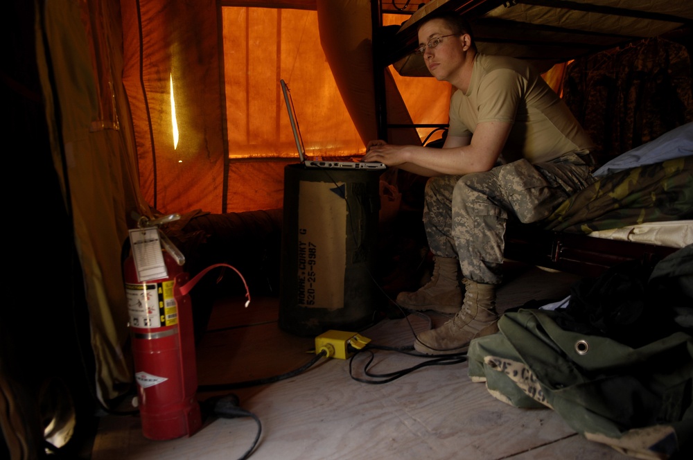 U.S. Army Spc. Corky Moore plays a game on his laptop.