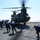 U.S. Navy sailors prepare to refuel an Army CH-47 Chinook helicopter.