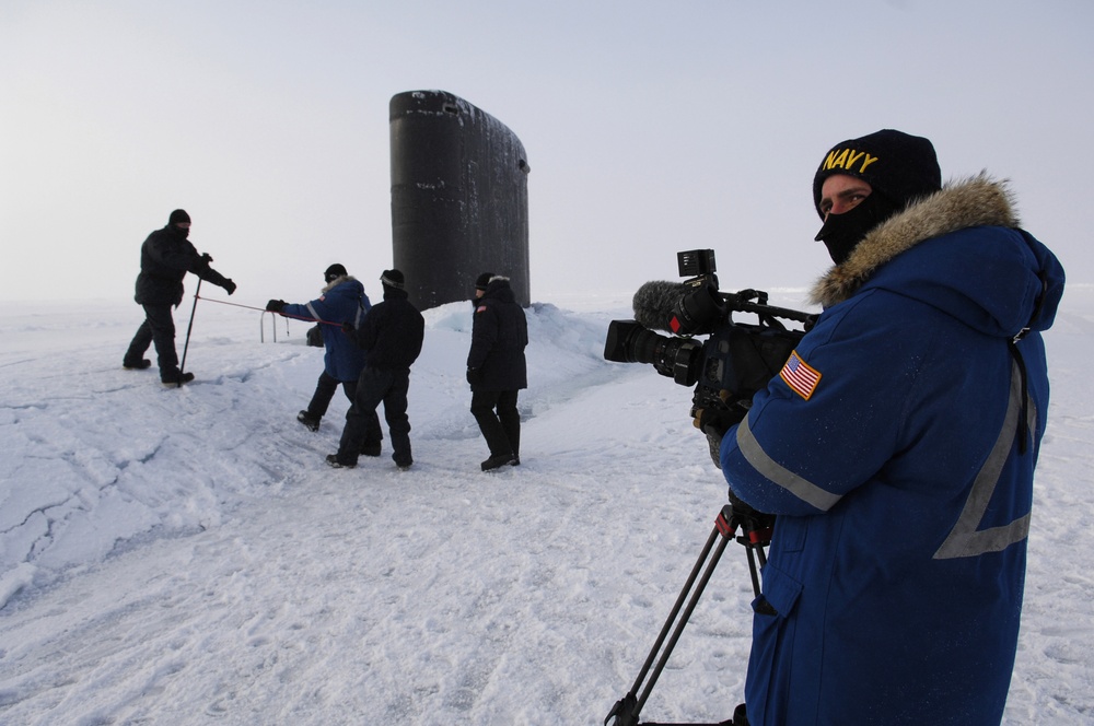 Petty Officer 2nd Class Andrew Krauss prepares to videotape visitors to the submarine USS Alexandria.