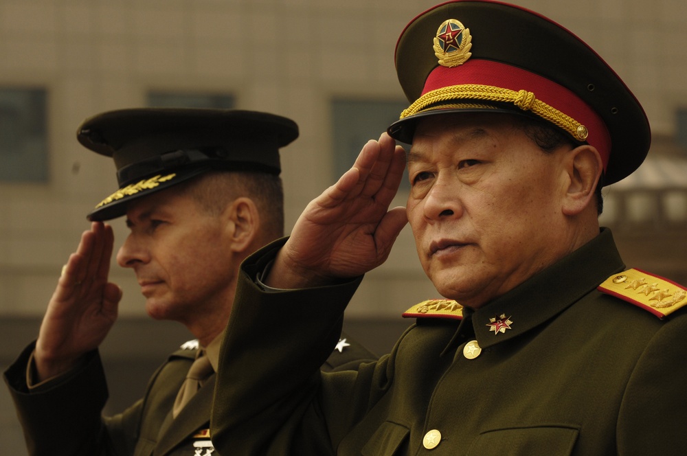 Gen. Peter Pace and his Chinese counterpart, Chinese People's Liberation Army Gen. Liang Guanglie salute.