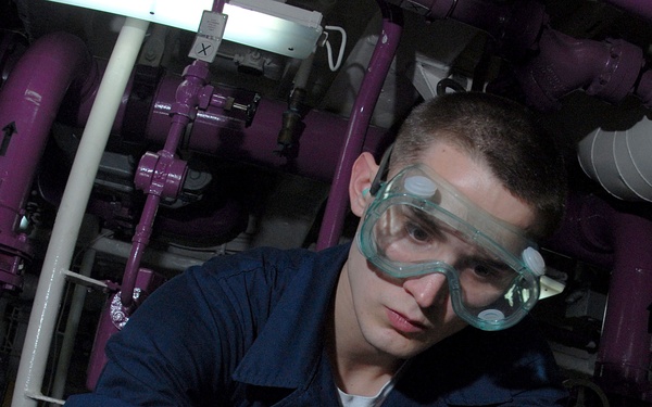U.S. Navy Airman Nicholas Audrian labels aircraft fuel samples.