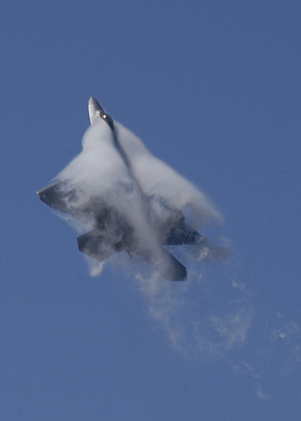 Water vapor forms around a U.S. Air Force F-22A Raptor.