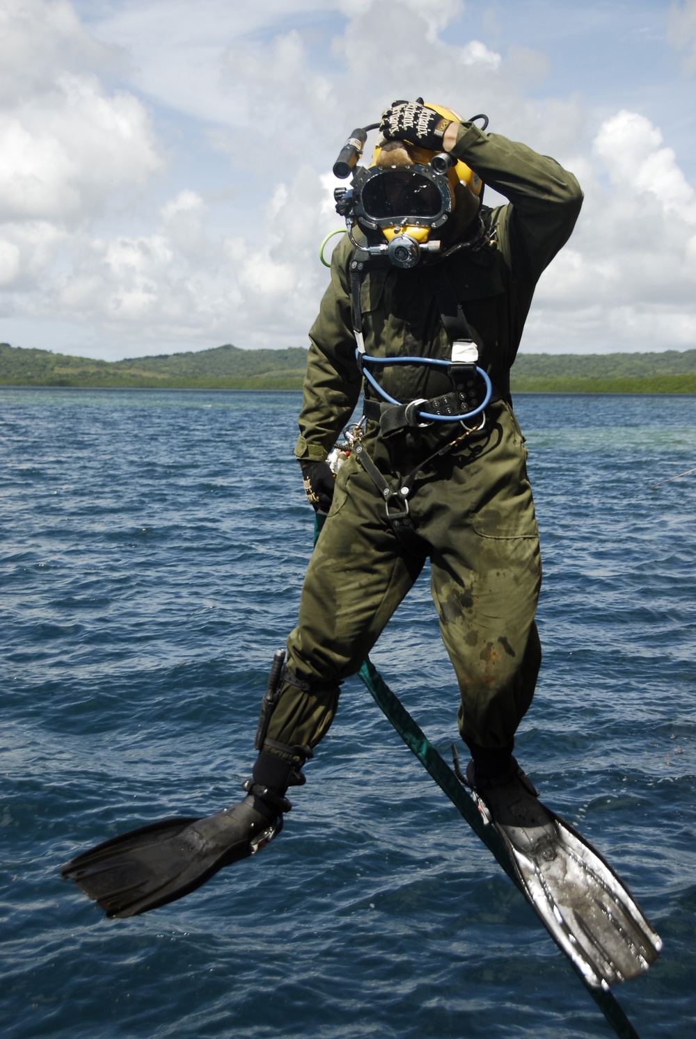 U.S. Navy Diver Curtis Wiley jumps off a dive station.