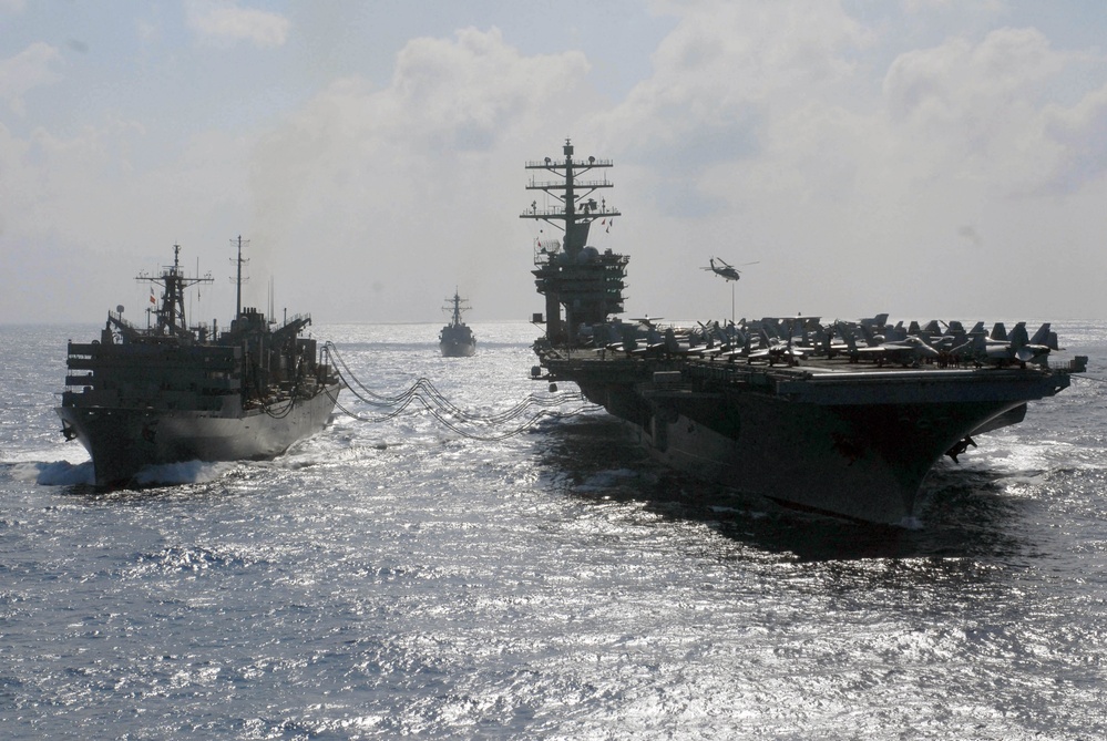 The Military Sealift Command ship USNS Rainier (T-AOE 7) performs a replenishment at sea.