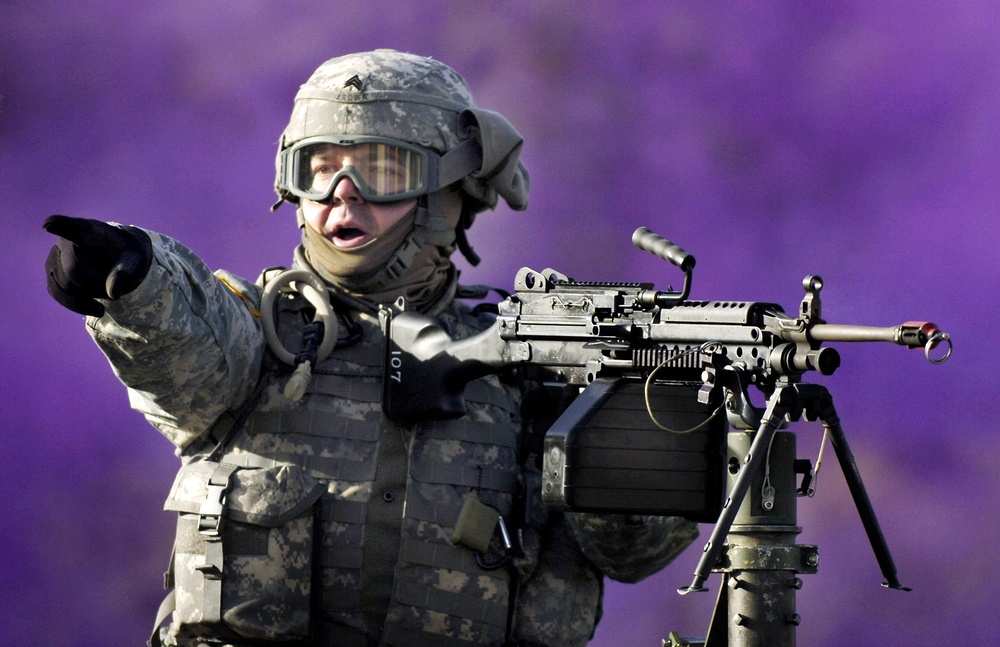 Sgt. Edgar Brown shouts to a gunner on his right.