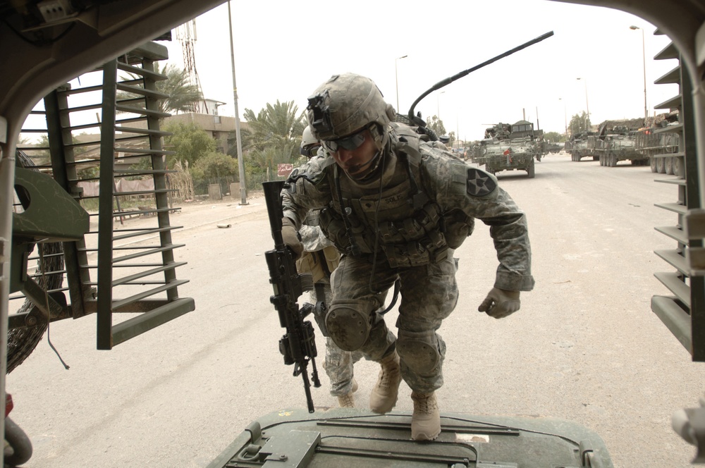 U.S. Army Spc. Solis enters a Stryker assault vehicle.