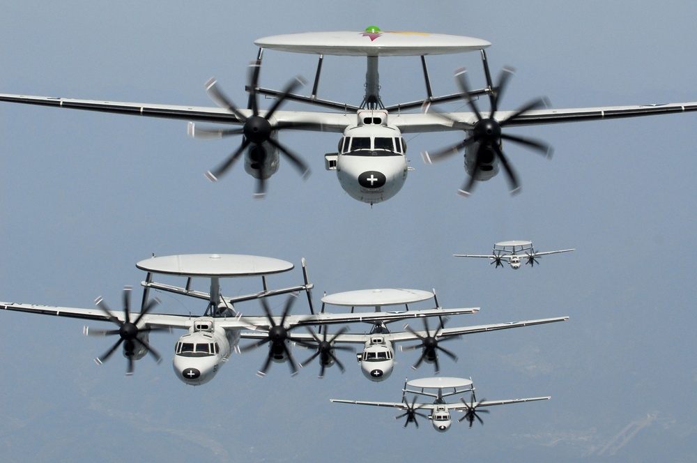 Five U.S. Navy E-2C Hawkeyes fly in formation.