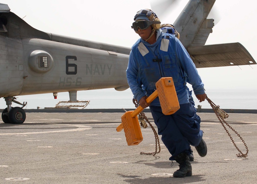 Petty Officer 3rd Class Dontay Jones removes chocks.