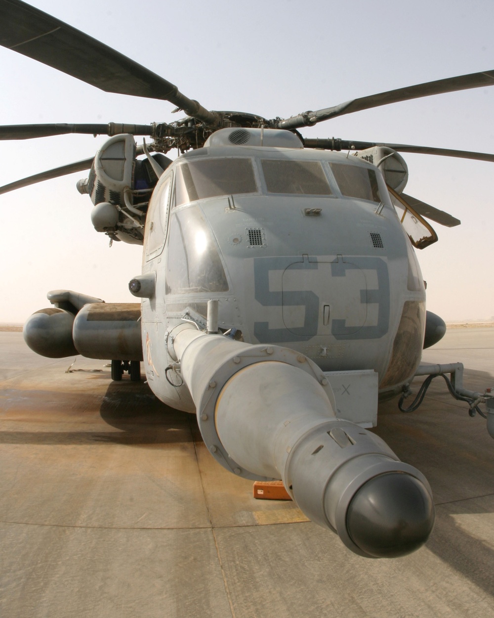 A CH-53E Super Stallion helicopter sits on the flight line at Al Asad Air Base.