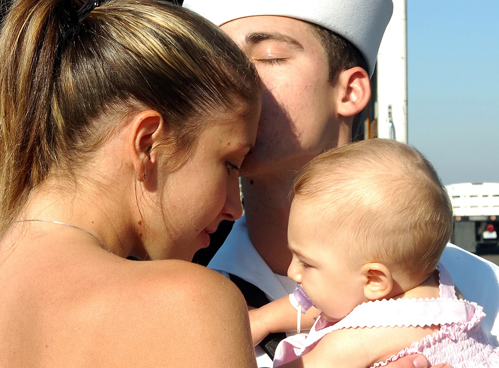 Boatswain's Mate 3rd Class Brian Sitarz embraces his wife.