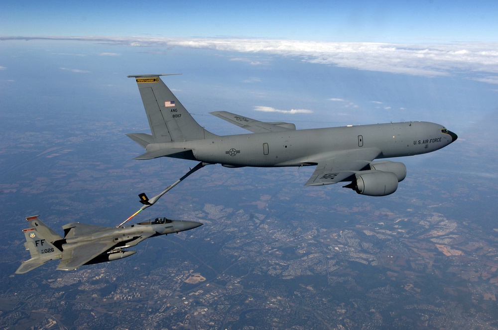 An F-15 Eagle aircraft receives fuel from a KC-135 Stratotanker aircraft.