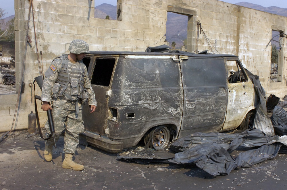 A U.S. Army soldier patrols in a neighborhood.