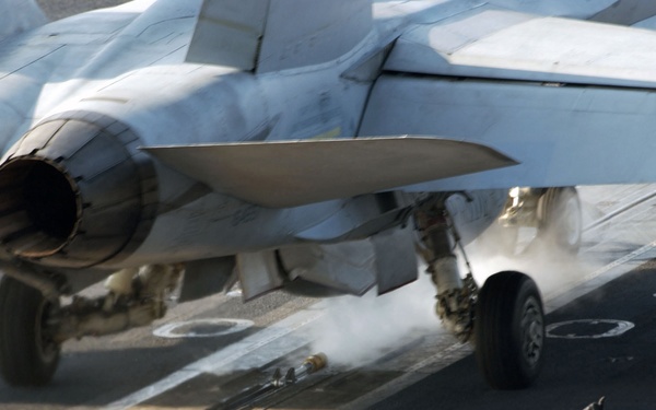 U.S. Navy flight deck personnel give the signal to launch an F/A-18C Hornet.