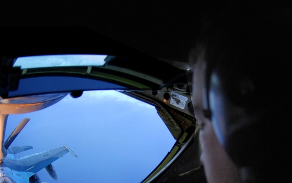 Staff Sgt. Daniel Maas carefully operates the boom of a KC-135 Stratotanker.