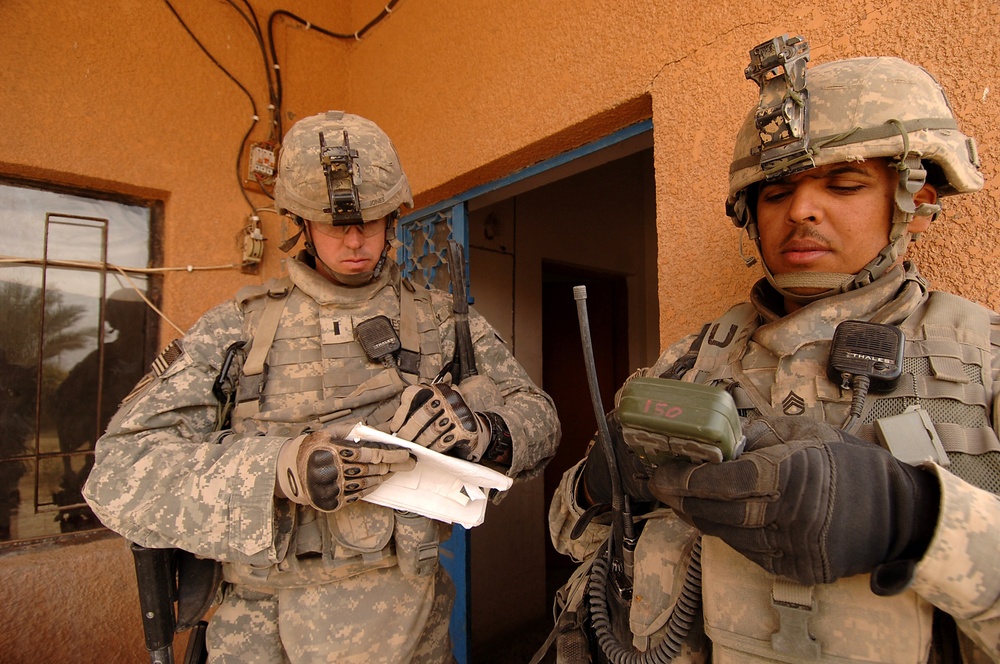 U.S. Army 1st Lt. Josh Jones receives a grid coordinate from a fellow soldier.