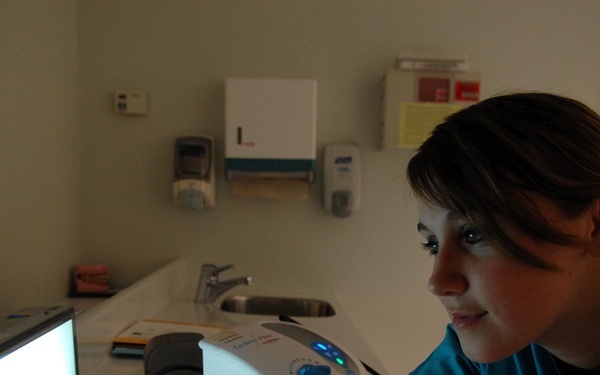 Airman 1st Class Alaina Clark looks at an x-ray.