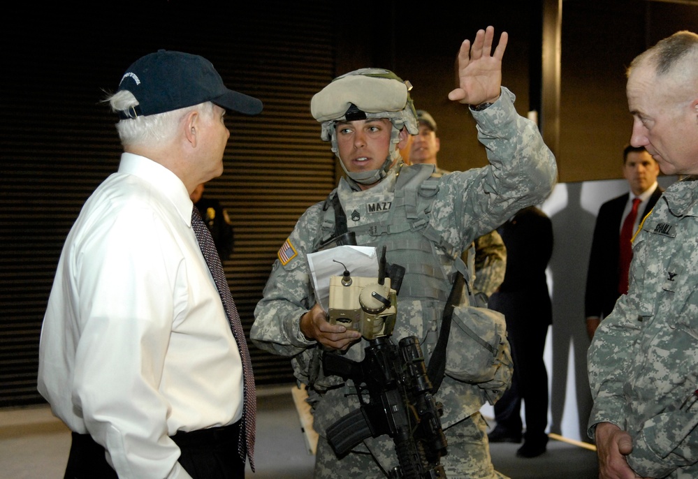 Secretary Gates listens to a briefing.