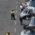 U.S. Navy flight deck crew members monitor the safety line.