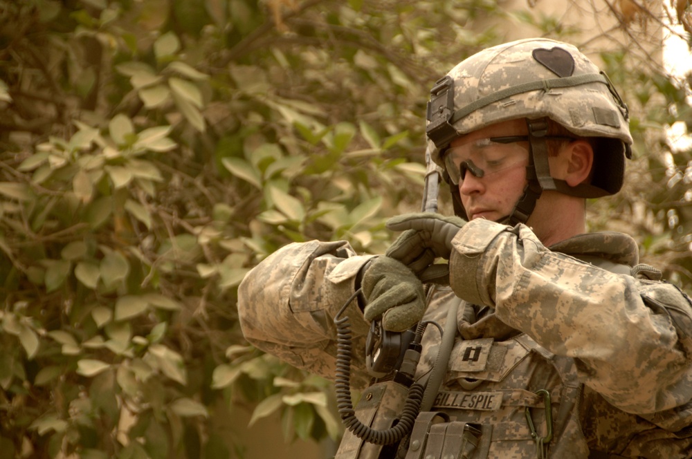 A U.S. Army soldier checks his watch.