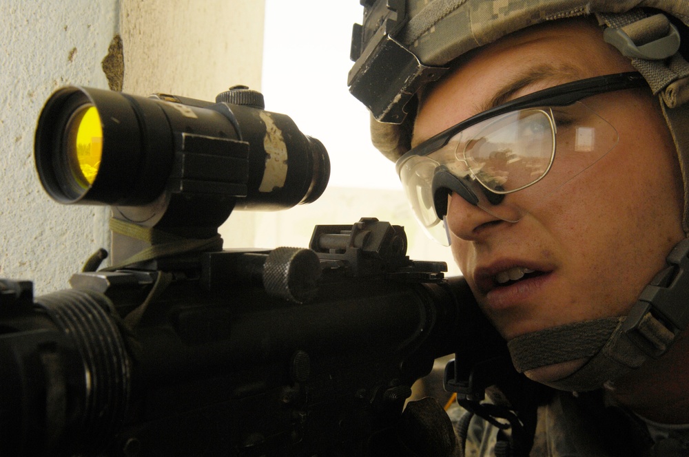 Pfc. Smith provides rooftop security for his dismounted teammates.