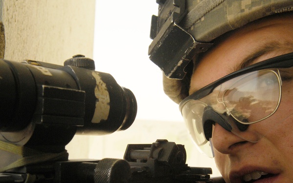 Pfc. Smith provides rooftop security for his dismounted teammates.