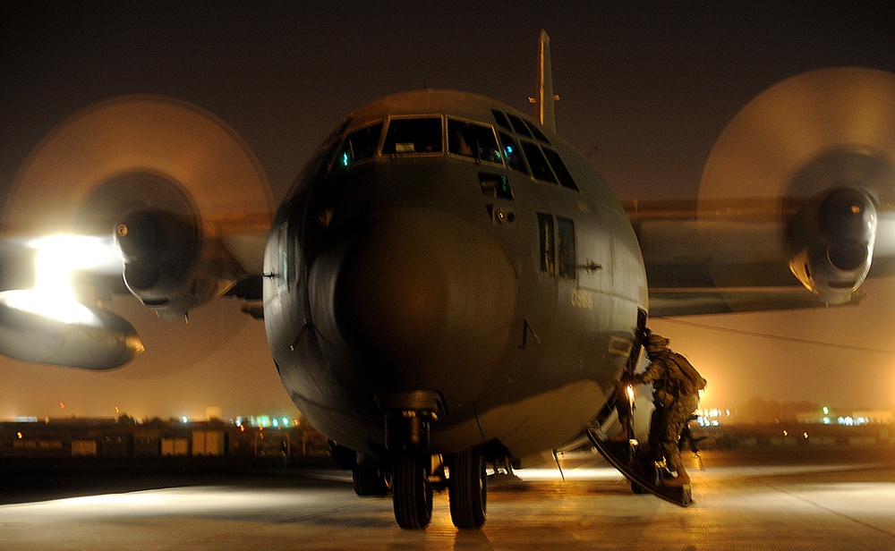 A U.S. Army soldier boards an HC-130 Hercules aircraft.