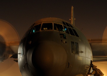 A U.S. Army soldier boards an HC-130 Hercules aircraft.