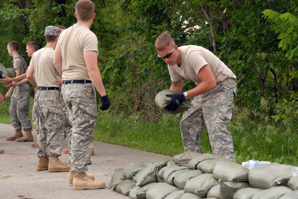 Spc. Kyle Weber places sandbags on the levee.
