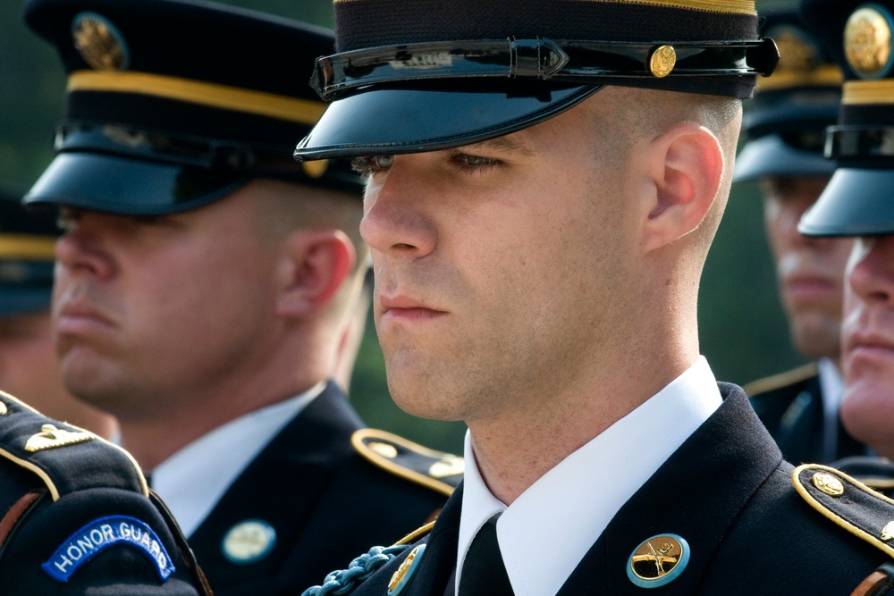 U.S. Army soldiers stand at attention for taps.