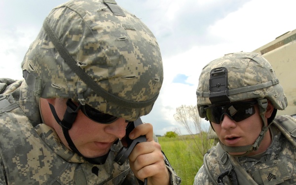 Spc. James D'Amico and Sgt. Timothy Boggs call for support from air assets.