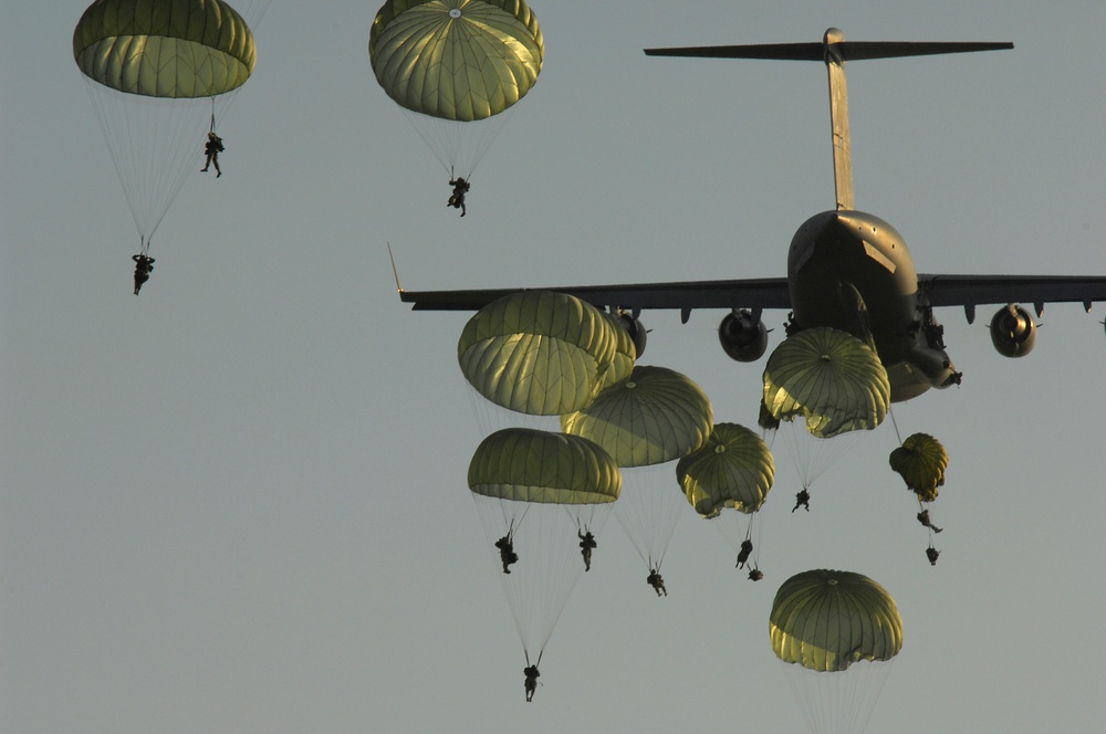U.S. Army paratroopers jump from a C-17 Globemaster III aircraft.