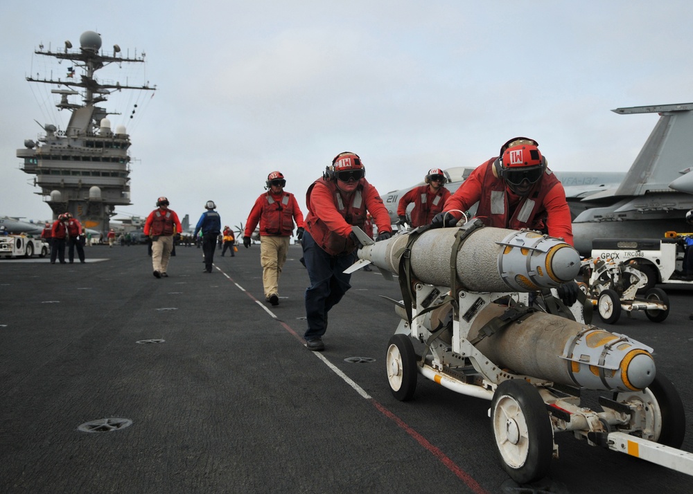 U.S. Navy aviation ordnancemen prepare to load ordnance.