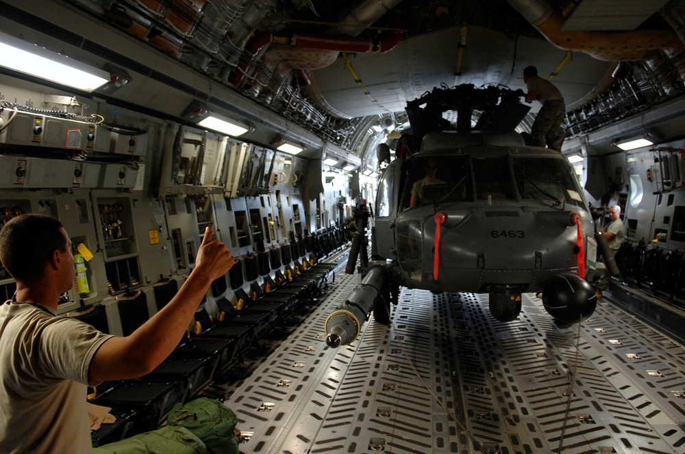 Tech. Sgt. Joseph Herrera signals other crew chiefs and loadmasters.