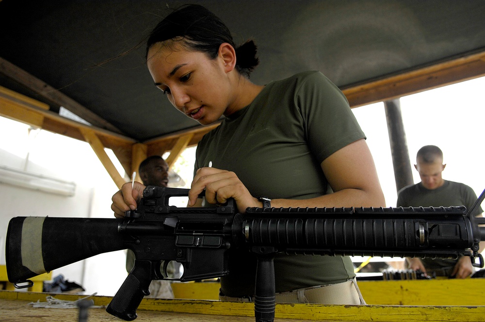 Cpl. Sheryl Verhulst cleans her M-16 assault rifle.