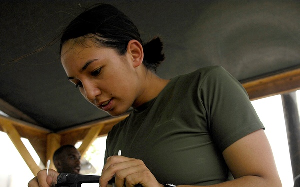 Cpl. Sheryl Verhulst cleans her M-16 assault rifle.