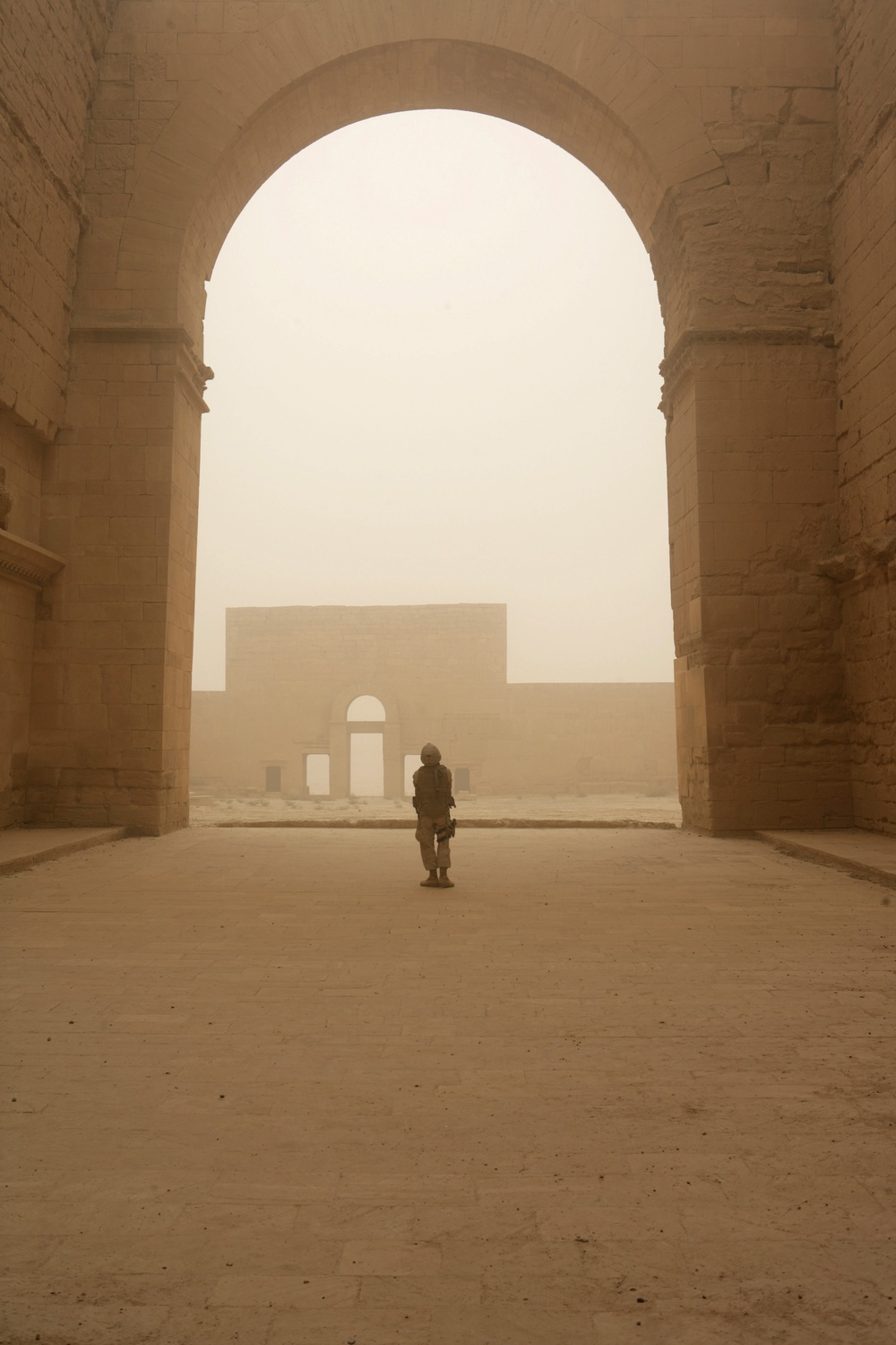 A U.S. Marine walks through the Hatra Ruins in the Jazeerah Desert.