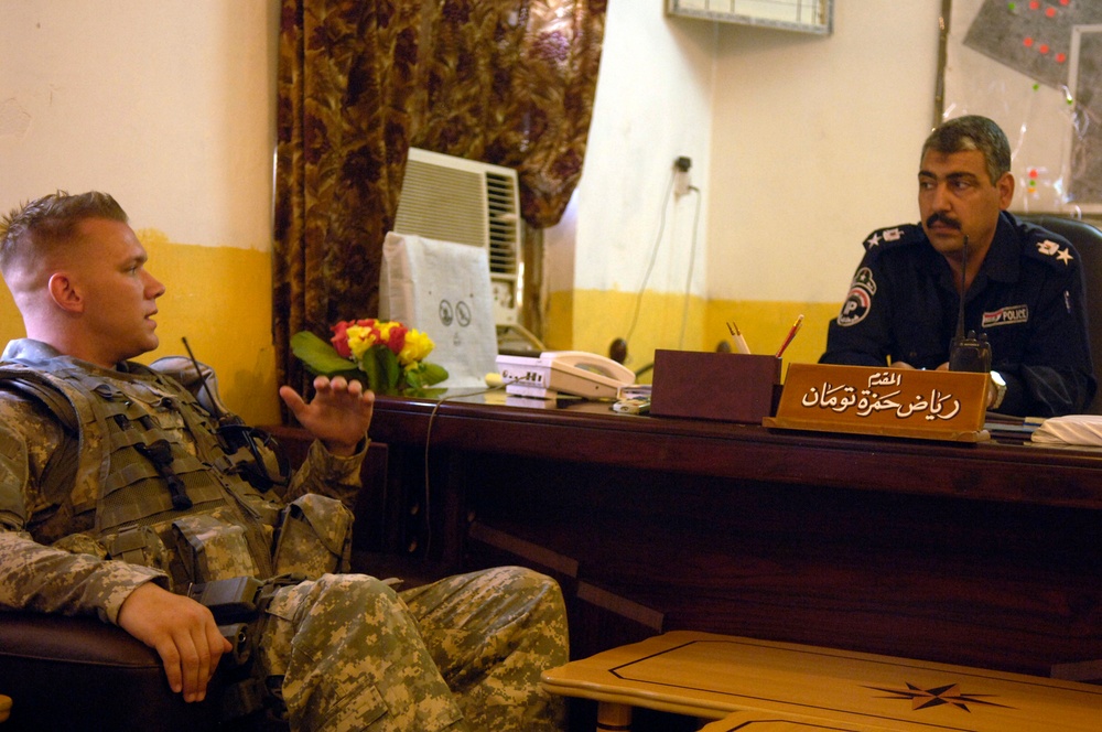 Sgt. Daniel Mulford meets with Iraqi Police Chief of the Hussein Station Lt. Col. Raxaq.