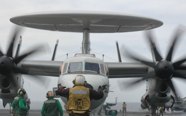 An E-2C Hawkeye aircraft approaches a catapult.