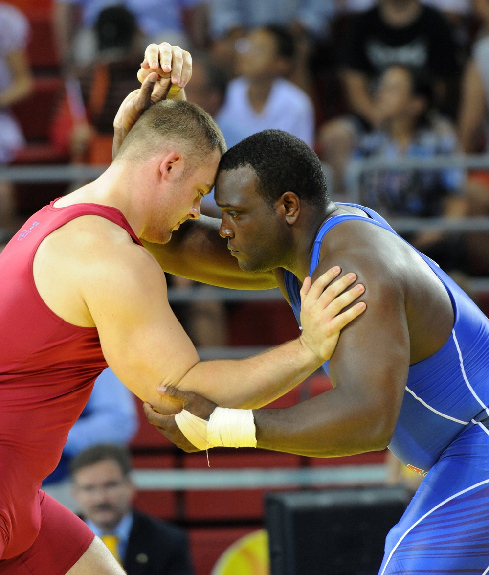 Staff Sgt. Dremiel Byers wrestles Sweden's Jalmar Sjoberg.