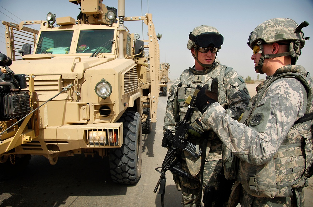 U.S. Army 1st Lt. Jonathan Kiel and 2nd Lt. Michael Cooper discuss route-clearing plans.