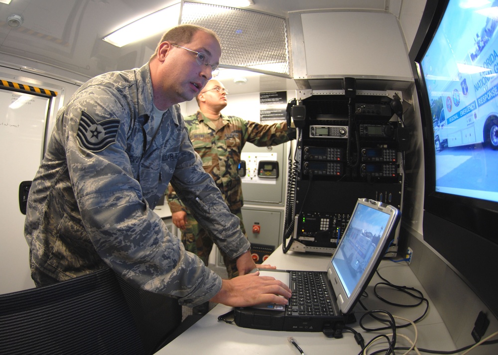 Tech. Sgt. Ray Simpson and Staff Sgt. Bryan Detro set up a communications link.