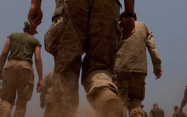 U.S. Marines search for spent brass.