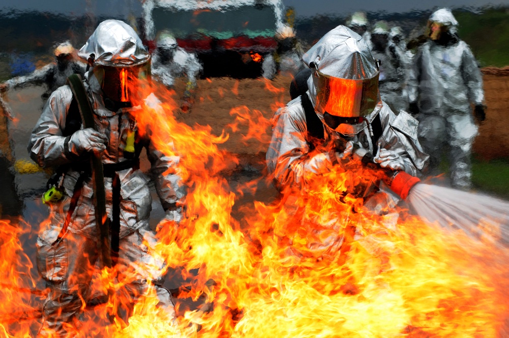 Daniel Scherer and Tech. Sgt. Christopher Parker battle a ground fire.