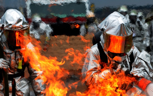 Daniel Scherer and Tech. Sgt. Christopher Parker battle a ground fire.