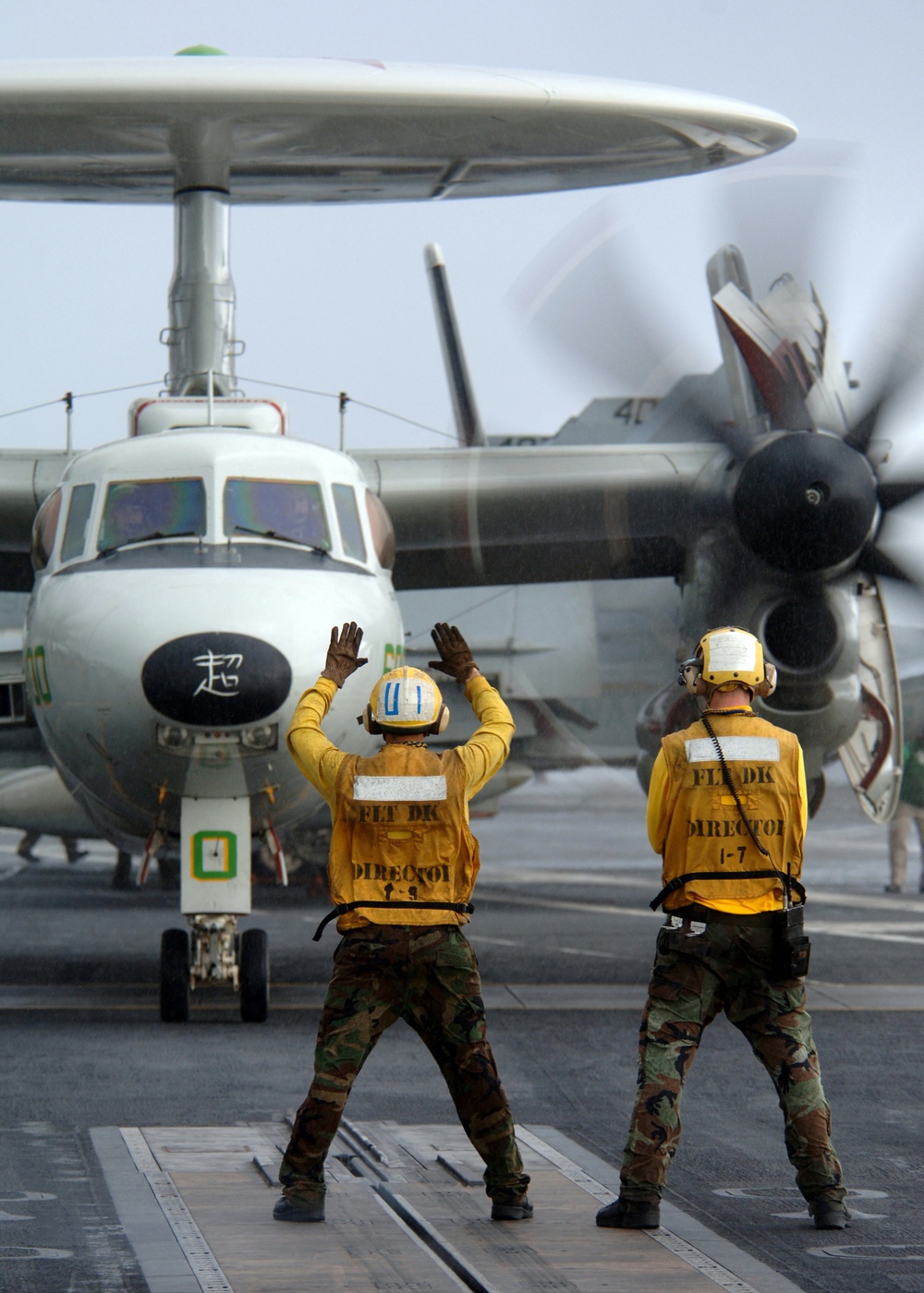 An E-2C Hawkeye aircraft approaches a catapult.