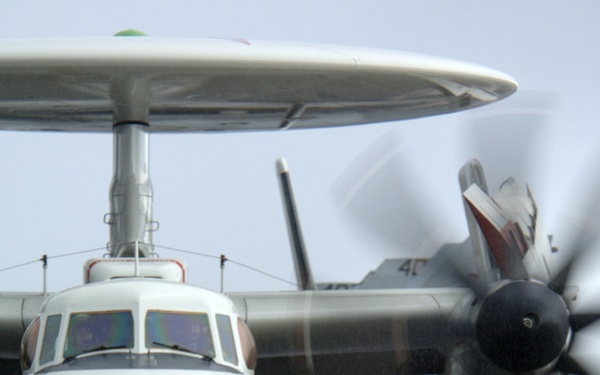 An E-2C Hawkeye aircraft approaches a catapult.
