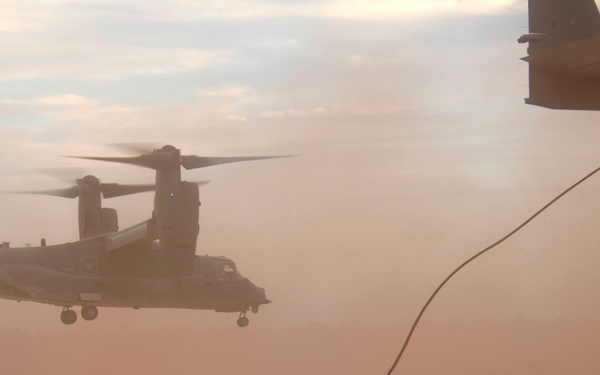 Special forces members disembark from CV-22 Osprey aircraft.